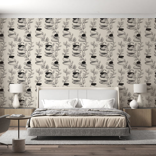 Une chambre moderne avec un papier peint illustrant des pierres empilées et des feuilles en noir sur fond beige, créant une atmosphère zen et apaisante.