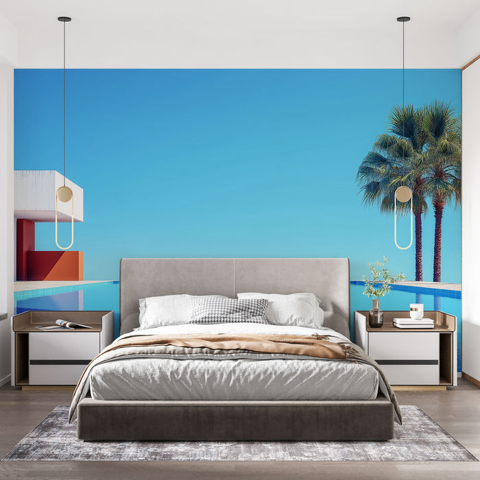Une chambre moderne avec un papier peint représentant une vue ensoleillée de palmiers et d'une piscine sur fond bleu, créant une atmosphère relaxante et estivale.