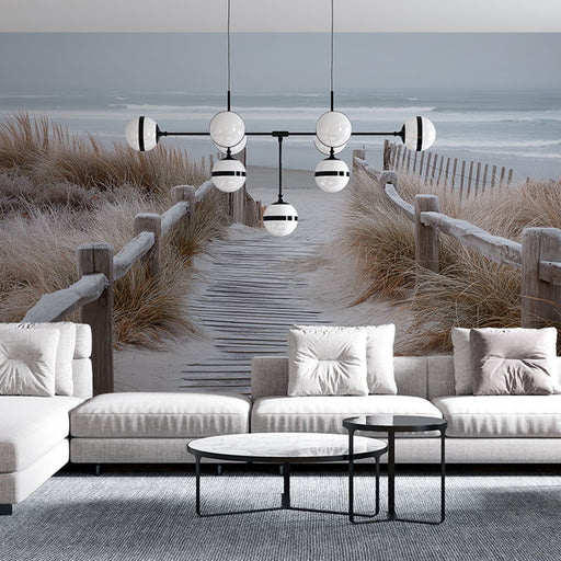 Un salon moderne avec un papier peint représentant un chemin de planches menant à la plage, créant une ambiance sereine et apaisante.