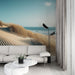Papier peint plage avec dunes dorées et mer tranquille pour salon moderne