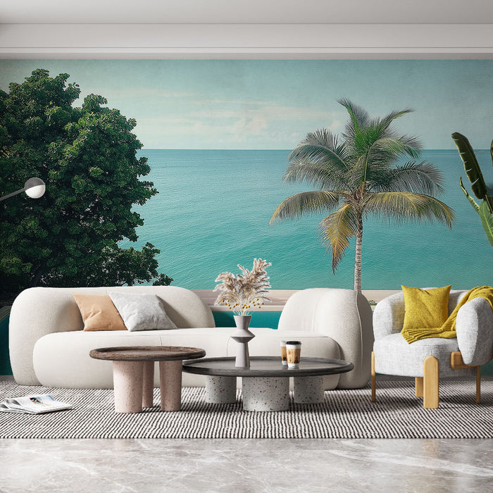 Un salon moderne avec un papier peint représentant un paysage marin apaisant, mêlant des teintes turquoise et des éléments naturels comme des palmiers et des feuillages.