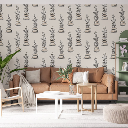 Un salon chaleureux avec un papier peint illustrant des plantes stylisées en noir sur fond clair, créant une atmosphère apaisante et naturelle.