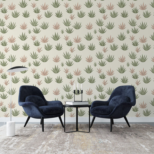 Un salon moderne avec un papier peint aux motifs de plantes stylisées dans des teintes douces de vert et de rose, créant une atmosphère apaisante et naturelle.