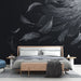 Une chambre moderne avec un papier peint noir illustré de plumes blanches délicates, créant une atmosphère élégante et apaisante.