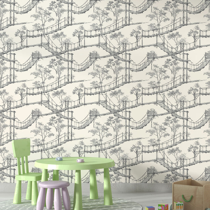 Une salle de jeux avec un papier peint illustrant des ponts suspendus et des arbres en noir sur fond crème, créant une atmosphère ludique et apaisante.