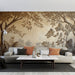 Un salon contemporain avec un papier peint texturé représentant des arbres et des feuilles en relief sur fond beige, créant une atmosphère chaleureuse et apaisante.