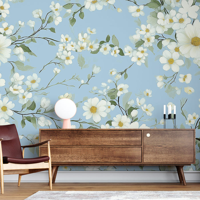 Une pièce moderne avec un papier peint floral sur fond bleu clair, orné de grandes fleurs blanches et de feuilles vertes, créant une ambiance fraîche et apaisante.
