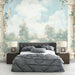 Une chambre élégante avec un papier peint mural représentant un paysage bucolique aux teintes douces, créant une atmosphère romantique et apaisante.