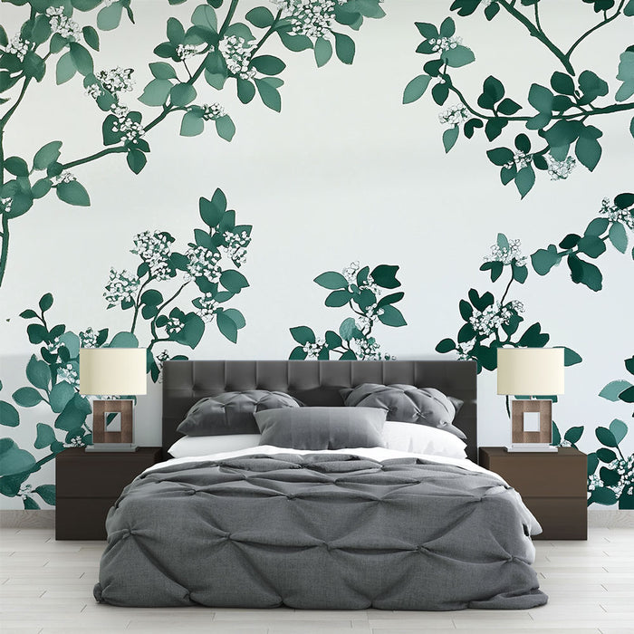 Une chambre moderne avec un papier peint floral vert émeraude illustrant des branches délicates et des fleurs blanches, créant une ambiance apaisante et naturelle.