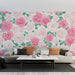 Un salon contemporain avec un papier peint floral aux roses roses et blanches, créant une ambiance romantique et chaleureuse.