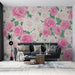Un salon moderne avec un papier peint floral aux roses roses et blanches sur fond clair, créant une ambiance romantique et chaleureuse.
