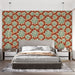 Une chambre moderne avec un papier peint floral aux motifs de succulentes vertes sur fond rouge orangé, créant une atmosphère chaleureuse et accueillante.