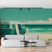 Un salon contemporain avec un papier peint illustrant une scène de plage, un van vintage vert et des planches de surf évoquant une ambiance estivale et décontractée.