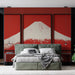 Une chambre moderne avec un papier peint représentant le mont Fuji sur fond rouge, créant une atmosphère audacieuse et artistique.