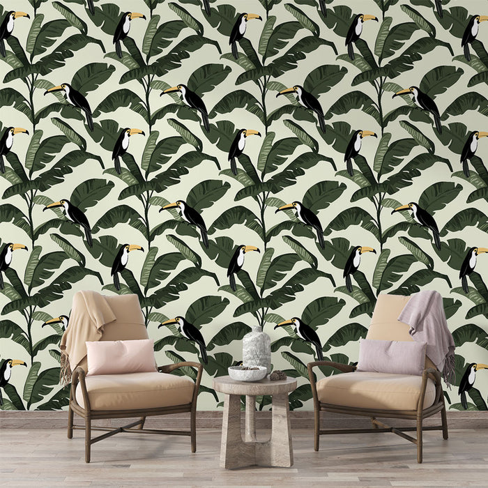 Une pièce de vie lumineuse avec un papier peint tropical représentant des toucans sur un fond clair, entourés de grandes feuilles vertes, créant une ambiance vivante et exotique.
