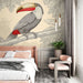 Une chambre moderne avec un papier peint illustrant un toucan coloré sur fond beige, créant une ambiance tropicale et vivante.