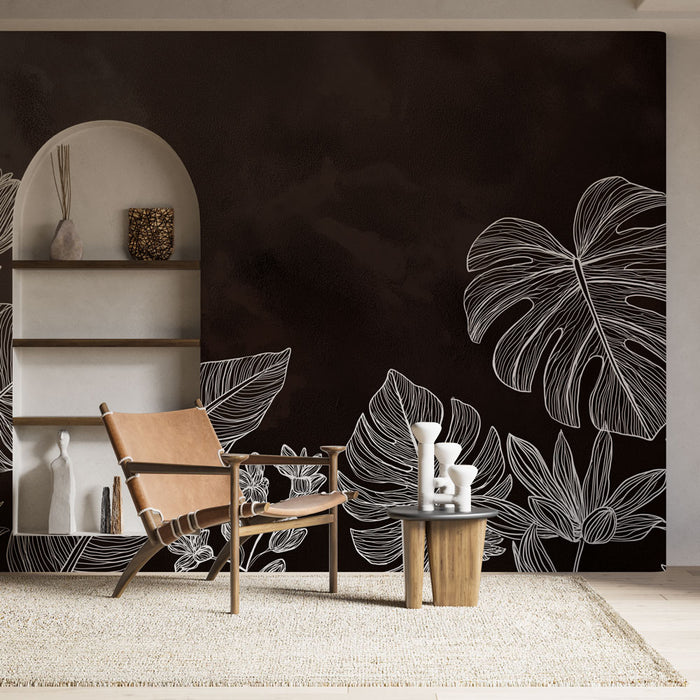 Une pièce moderne avec un papier peint noir orné de motifs de feuilles blanches, créant une ambiance élégante et contemporaine.