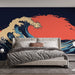Une chambre moderne avec un papier peint représentant une grande vague stylisée sur fond rouge et bleu, évoquant une atmosphère dynamique et apaisante.