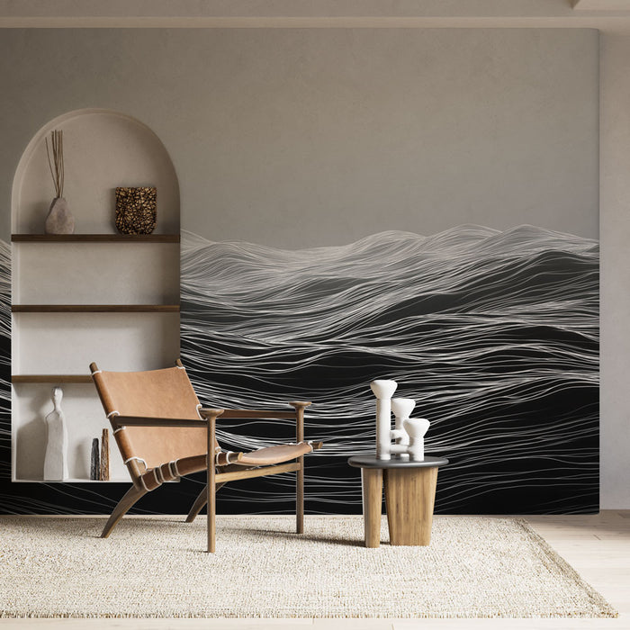 Une pièce moderne avec un papier peint abstrait représentant des vagues en noir et blanc, créant une ambiance apaisante et contemporaine.