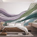 Une chambre moderne avec un papier peint abstrait aux ondulations vertes, violettes et bleues, créant une atmosphère apaisante et artistique.