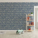 Une chambre d'enfant avec un papier peint bleu marine orné de motifs de vagues blanches, créant une ambiance ludique et apaisante.