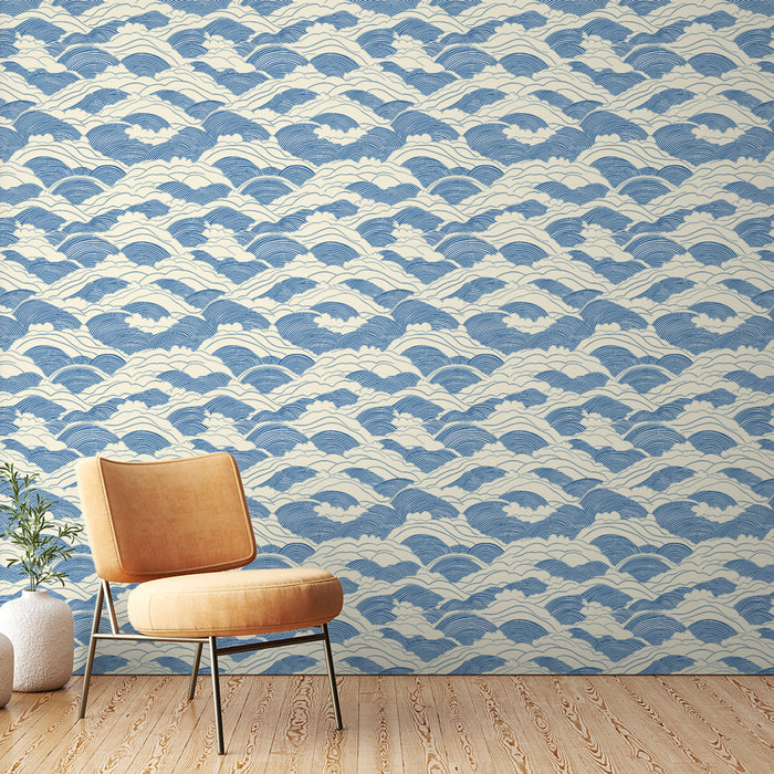 Une pièce moderne avec un papier peint aux motifs de vagues bleues sur fond crème, évoquant une ambiance apaisante et maritime.